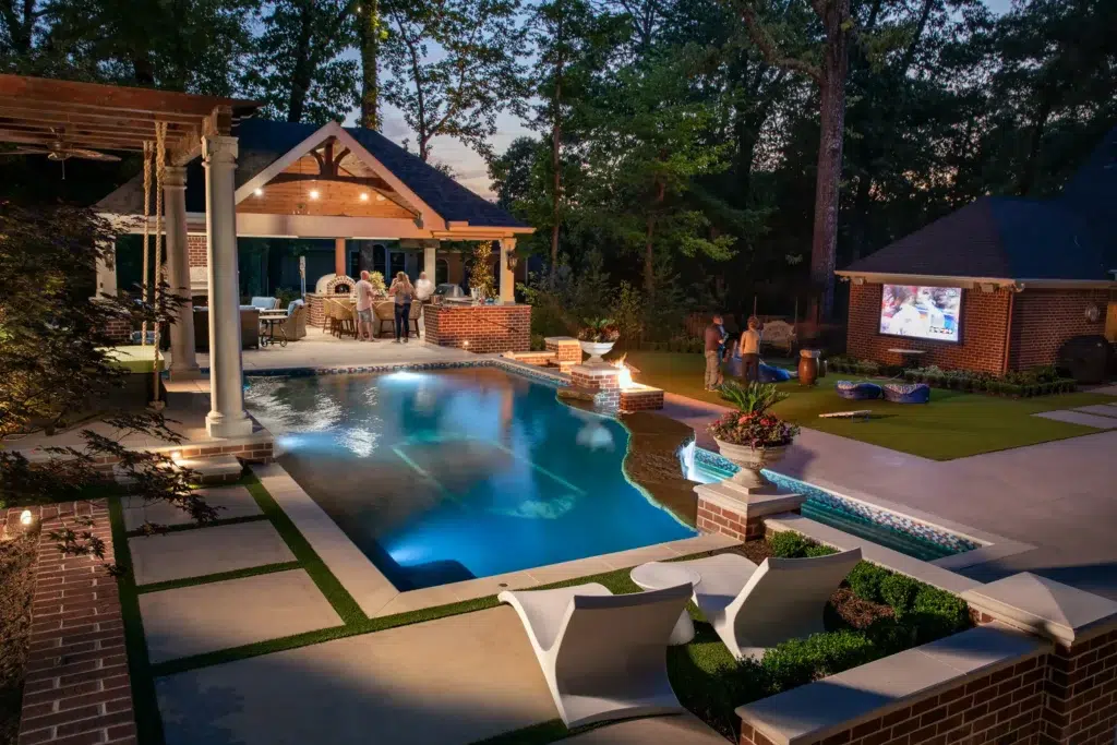 Outdoor living space at The Woods including pool and spa, outdoor structure, and landscaping