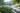 Estate-level landscape design with stone walls, garden beds, and structured walkways in East Texas