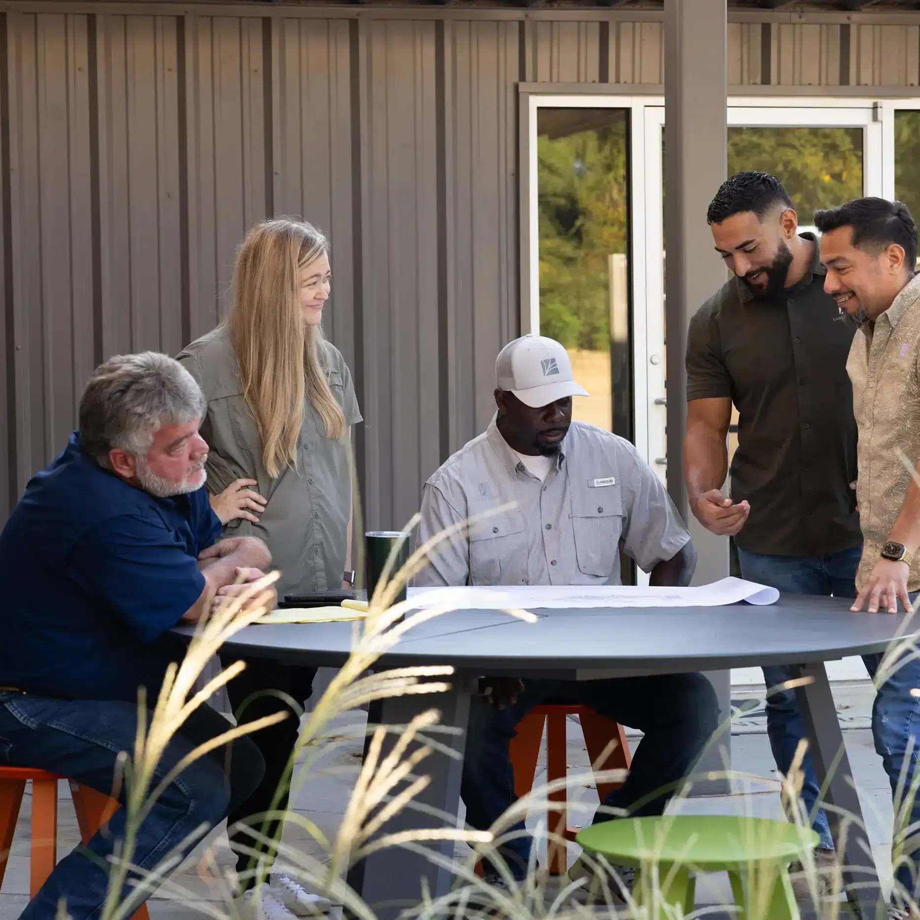Landvisions landscape design and construction team reviewing project plans together at Tyler Texas headquarters